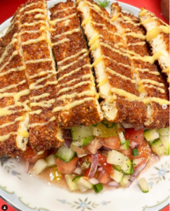 Chicken Schnitzel over Israeli Salad